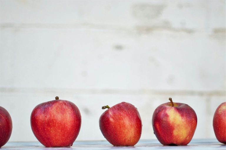 A number of red apples neatly arranged in a row